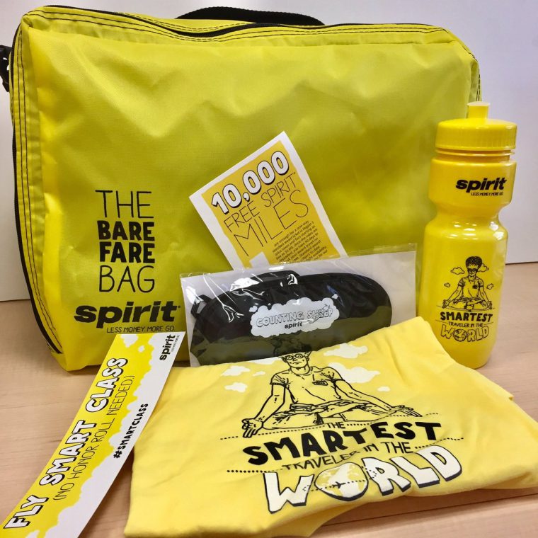 The Bare Fare Bag giveaway kit: a yellow bag, T-shirt, bottle and Smartest Traveler in the World swag.