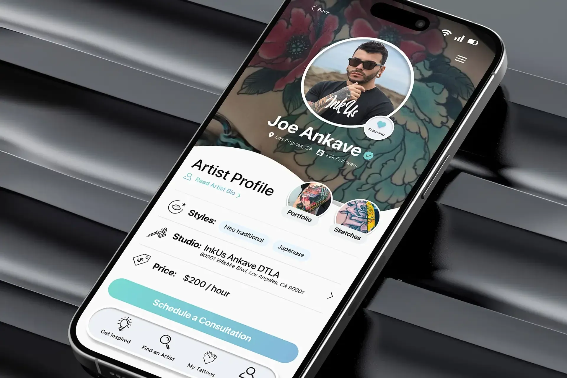 A phone showing Joe Ankave’s artist profile in Ink Us.