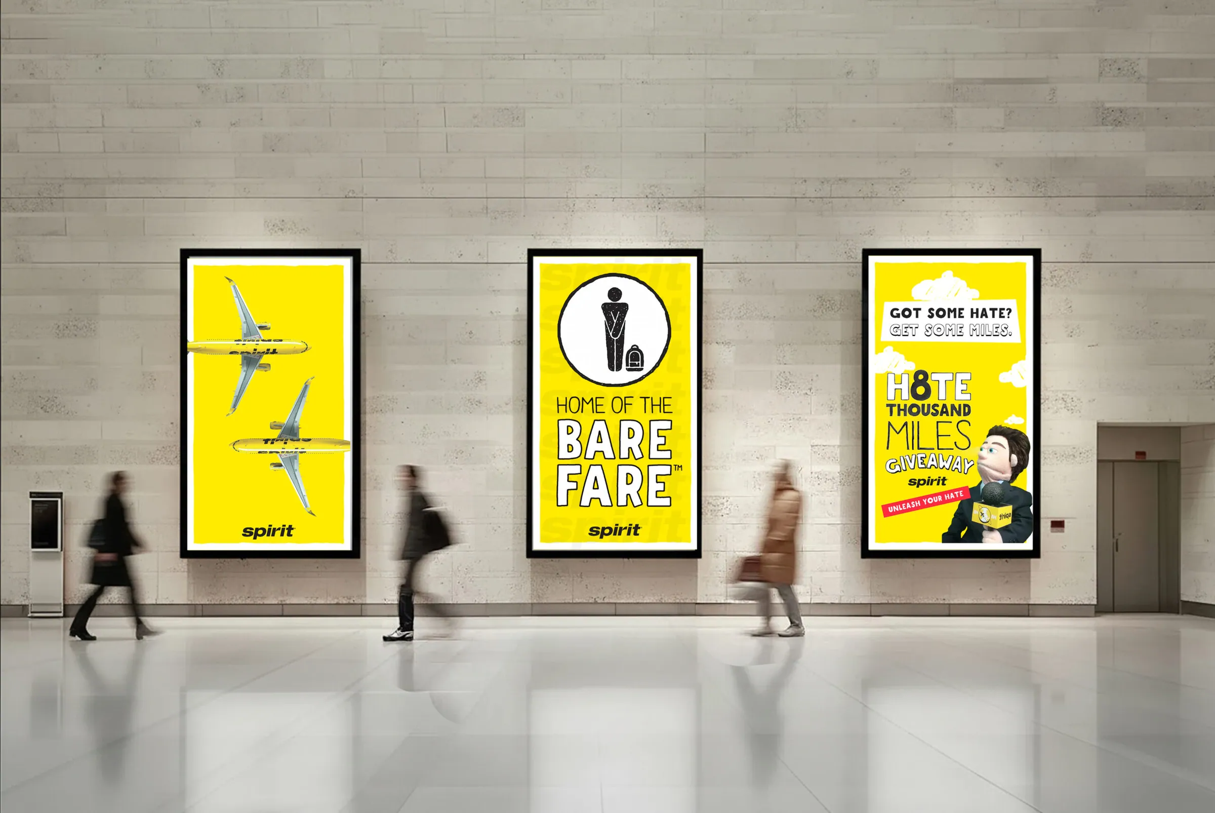 Three Spirit posters in a stone concourse as travelers walk past.